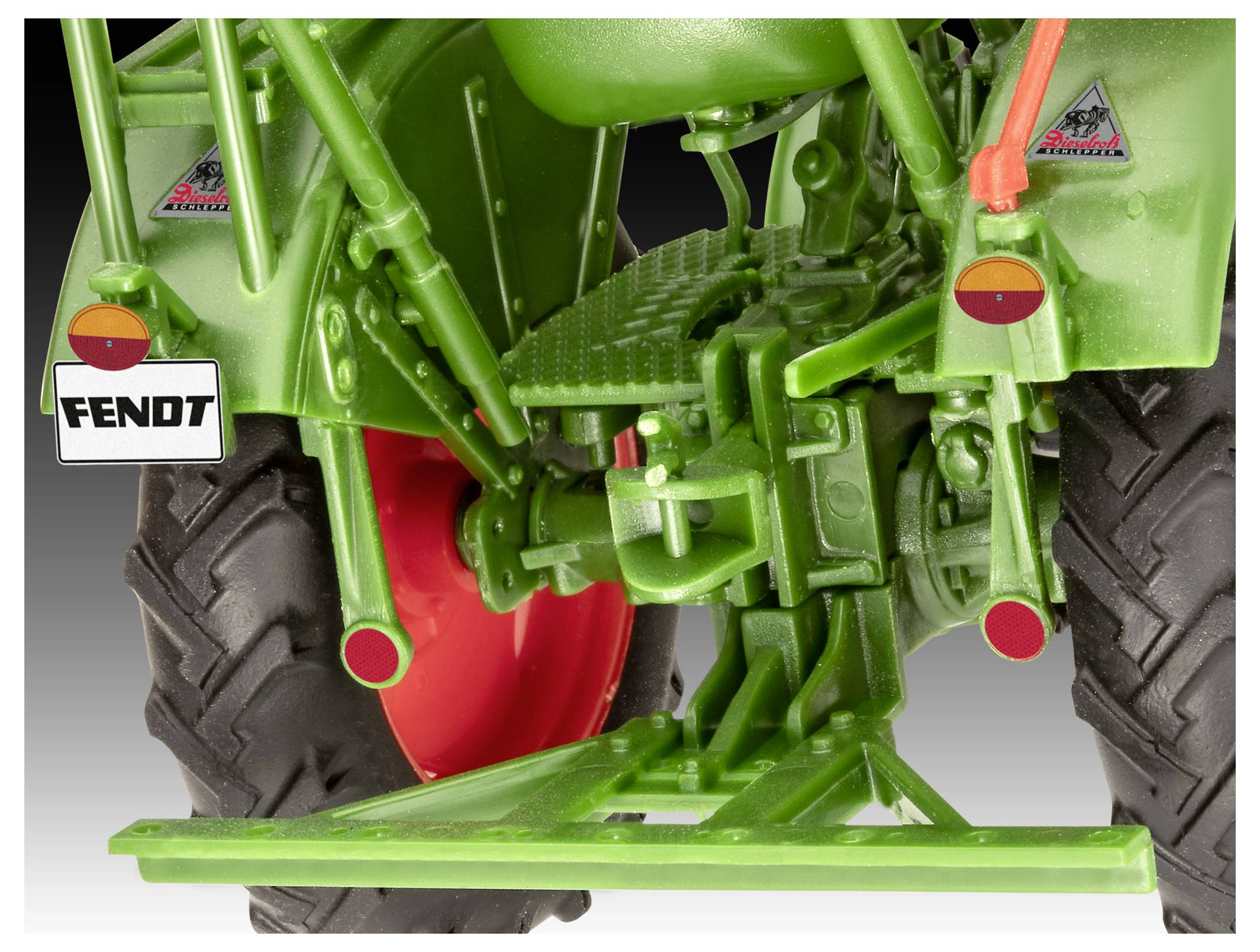 Close-up view of the rear of a green Fendt tractor model with red wheels, showing mechanical details and a license plate.