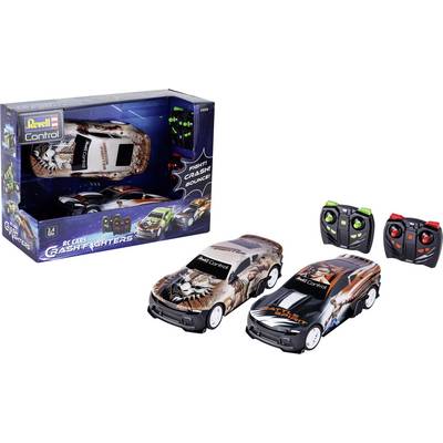 Two toy cars and remote controllers, branded 'Revell Control Crash Fighters,' with a box displaying action images and text 'Fight, Crash, Bounce!'.