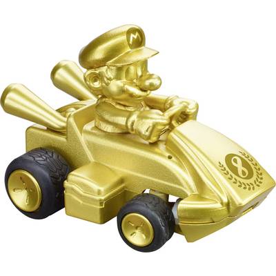 A golden toy car with a character driving, featuring a cap and mustache. It has four wheels and two exhaust pipes in the back.