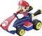 A toy character in a red hat and blue outfit sits in a blue and white toy kart with large wheels, resembling a racing car.