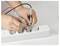 'A person using multimeter probes on a power strip, checking the electrical current.'