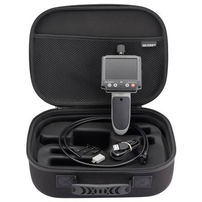 Open hard case containing a VOLTCRAFT inspection camera with handheld screen, cable, adapters, and accessories neatly stored inside.