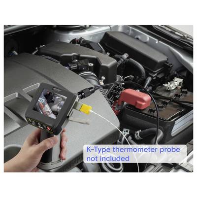 Handheld infrared thermometer aimed at a car engine bay, with on-image text noting 'K-Type thermometer probe not included'.