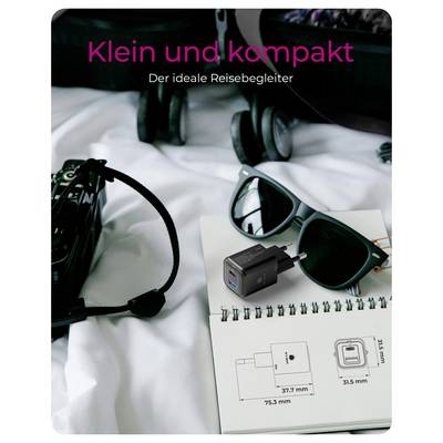 'A pair of sunglasses, a camera, and a travel plug adapter on a notebook in a suitcase. Text reads: ‘Klein und kompakt, Der ideale Reisebegleiter.’'