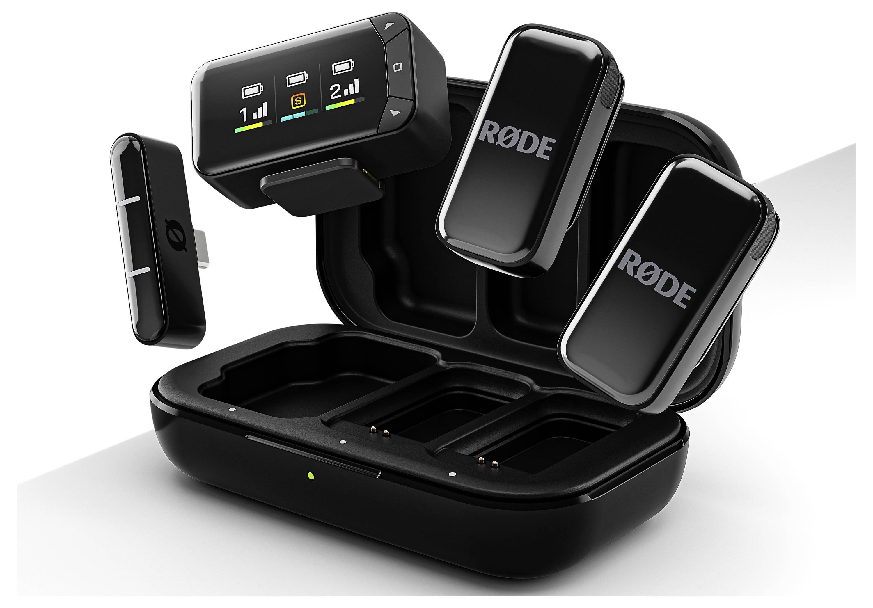 Open black charging case with RØDE wireless microphone transmitters and receiver, showing battery indicators on digital display.