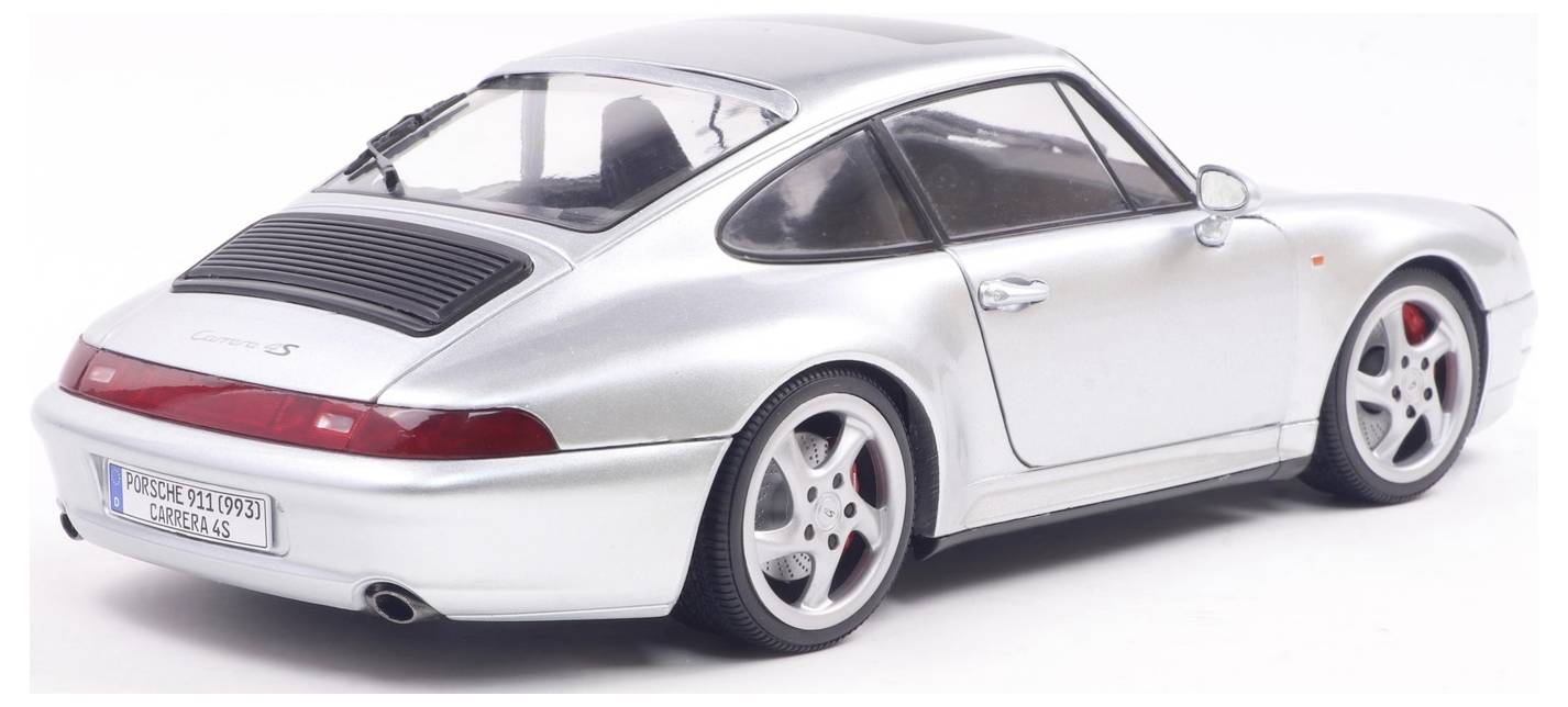 A silver sports car model with sleek curves and red brake calipers, viewed from the back and side, showcasing its aerodynamic design.