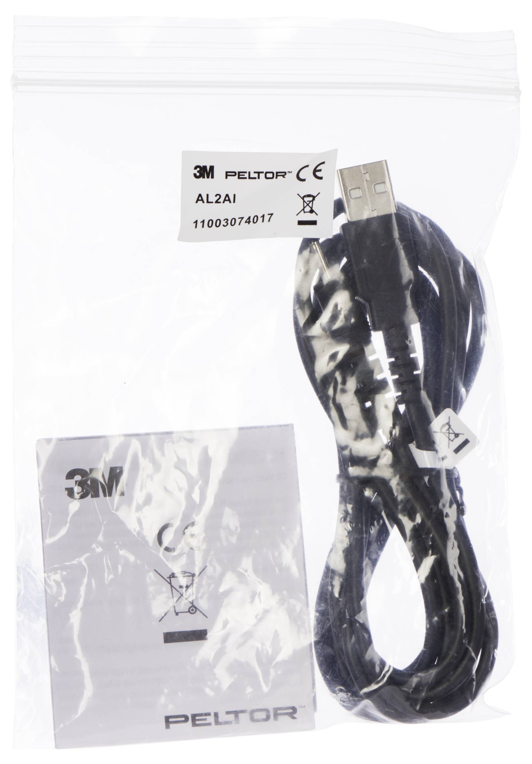 A plastic bag contains a USB charging cable and a Peltor instruction manual.