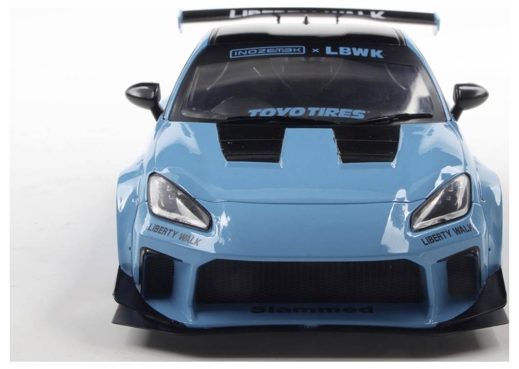 A blue toy race car model with 'Liberty Walk' and brand decals, featuring a large spoiler and sporty design against a plain background.