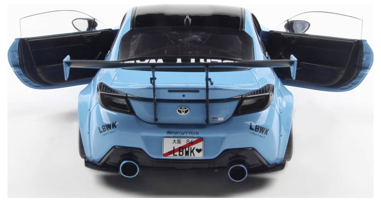 A blue sports car viewed from the rear, showing wide tires, a large spoiler, and open doors. The license plate reads 'LBWK'.