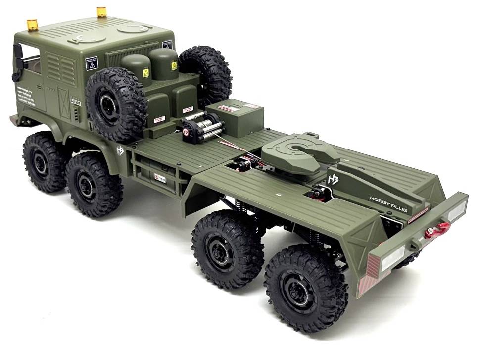 A green military-style six-wheeled toy truck with a flatbed and spare tires on the back, shown from a rear, side angle.