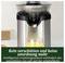 'Silver juicer on worktop; glass of freshly pressed juice in the foreground. Text: No more spillage thanks to intelligent drip stop.'