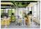 'Modern office space with green and yellow accents, open workstations, ergonomic chairs, and a glass meeting room labeled 5.'