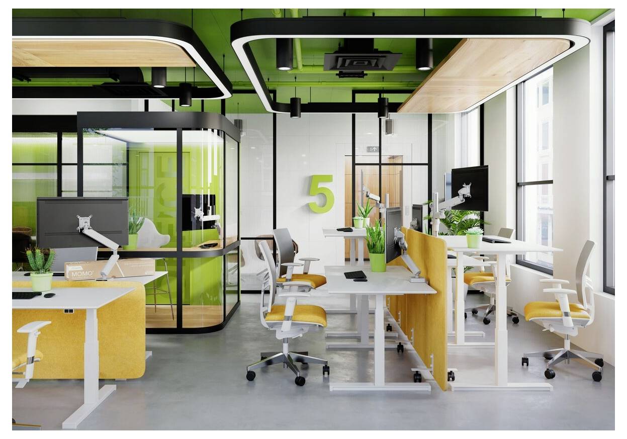 Modern office with vibrant green and yellow accents, featuring ergonomic desks, several computer stations, and a meeting pod.