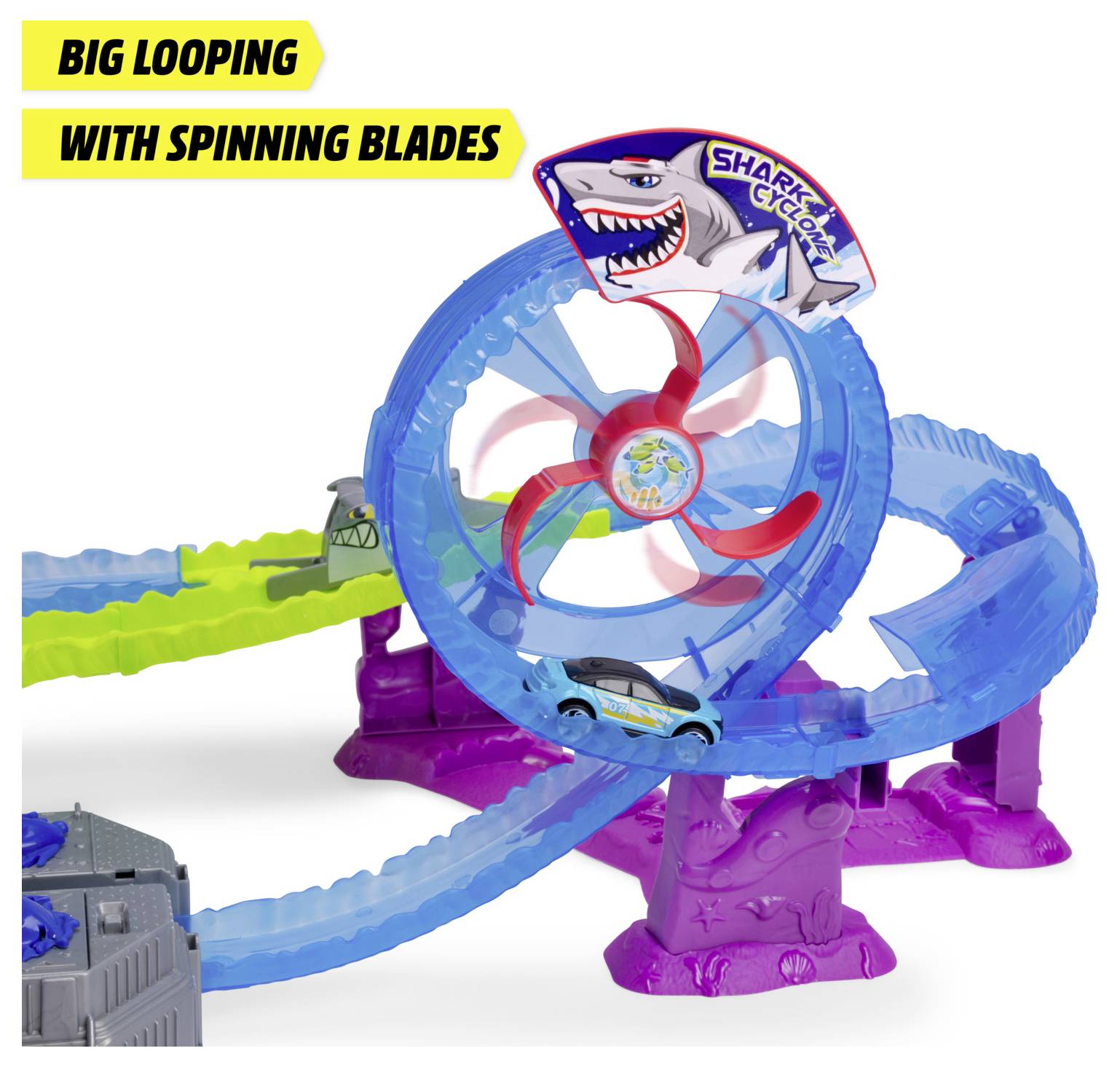 A toy car on a blue looped track with spinning red blades, featuring a 'Shark' theme. Text reads 'Big Looping with Spinning Blades'.