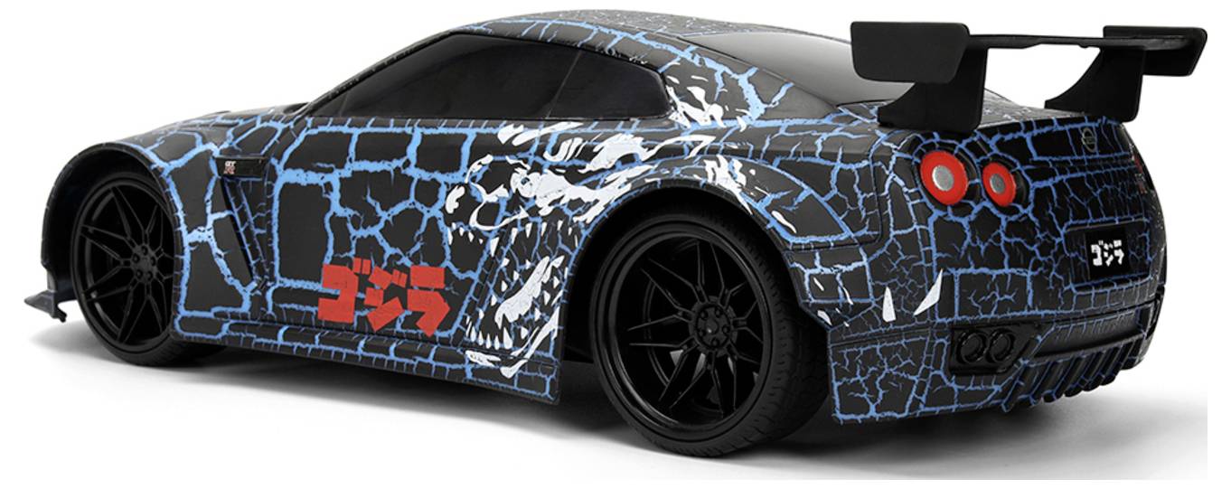 A sleek, black sports car with blue crackle pattern, red Japanese text on side, large rear spoiler, and intricate wheel design.