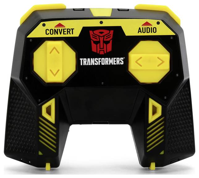 A toy remote control with yellow buttons labeled 'Convert' and 'Audio', featuring a 'Transformers' logo in the center, against a white background.