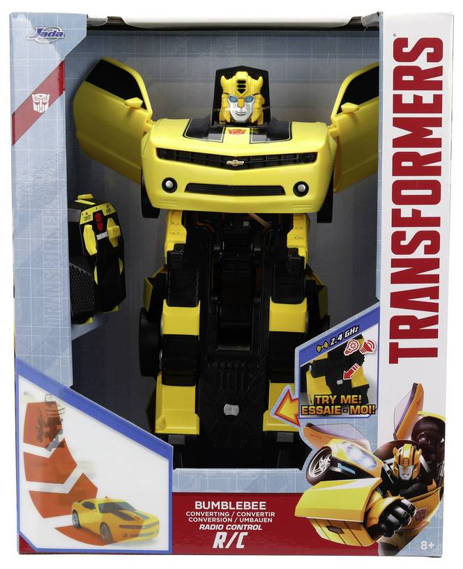 A toy action figure of a yellow robot with car-like features from the 'Transformers' series. The package includes 'Try Me' and 'Ages 8+' labels.