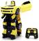 A yellow and black toy car transforms into a robot, standing upright. A remote control nearby shows buttons labeled 'Convert' and 'Audio'.