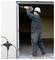 'Person in construction gear using a power drill on a garage door frame; text reads "Power cord not included."'