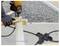 'A worker using a drill on a wooden board, with a power splitter shown nearby. Note: Power cord not included.'