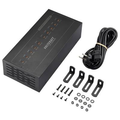 A black Voltcraft power supply with multiple output ports, power cable, and mounting accessories including screws and brackets are displayed.