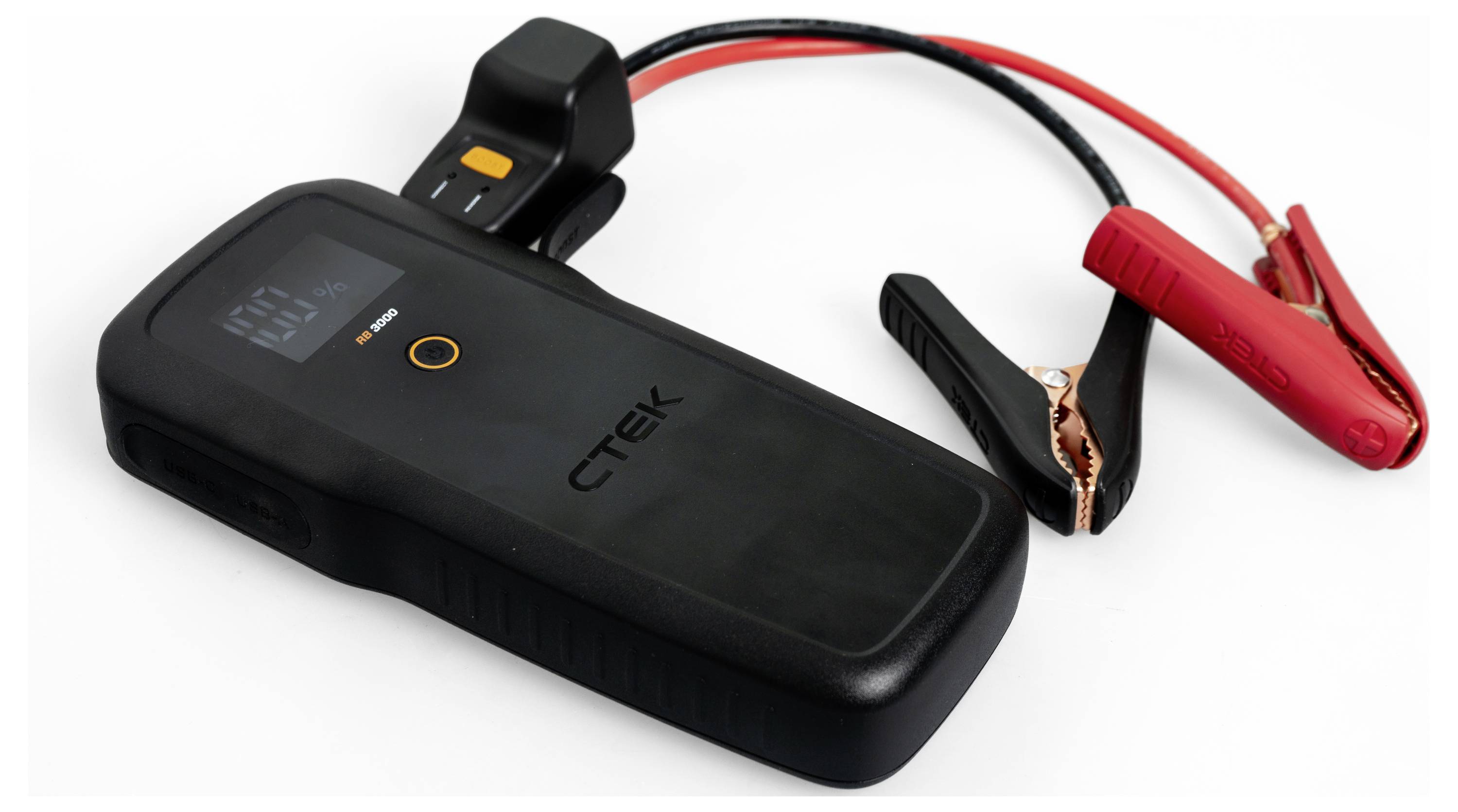 A black CTEK battery charger with attached red and black clamps on a white background.