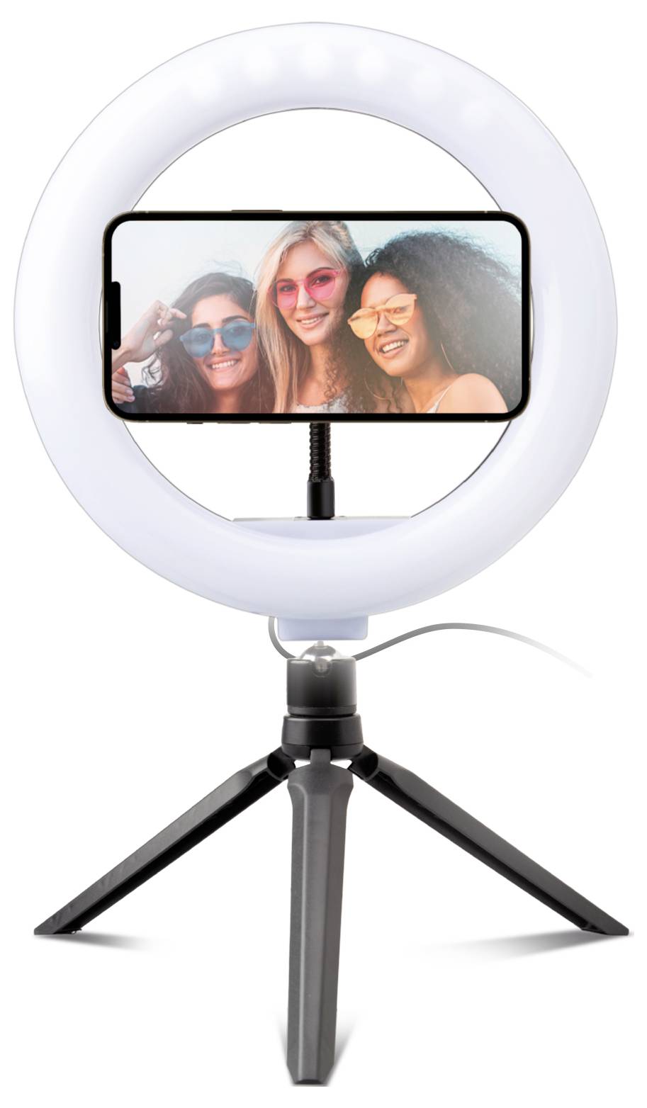 A ring light on a tripod with a smartphone attached in the center displaying a selfie of three smiling people outdoors.