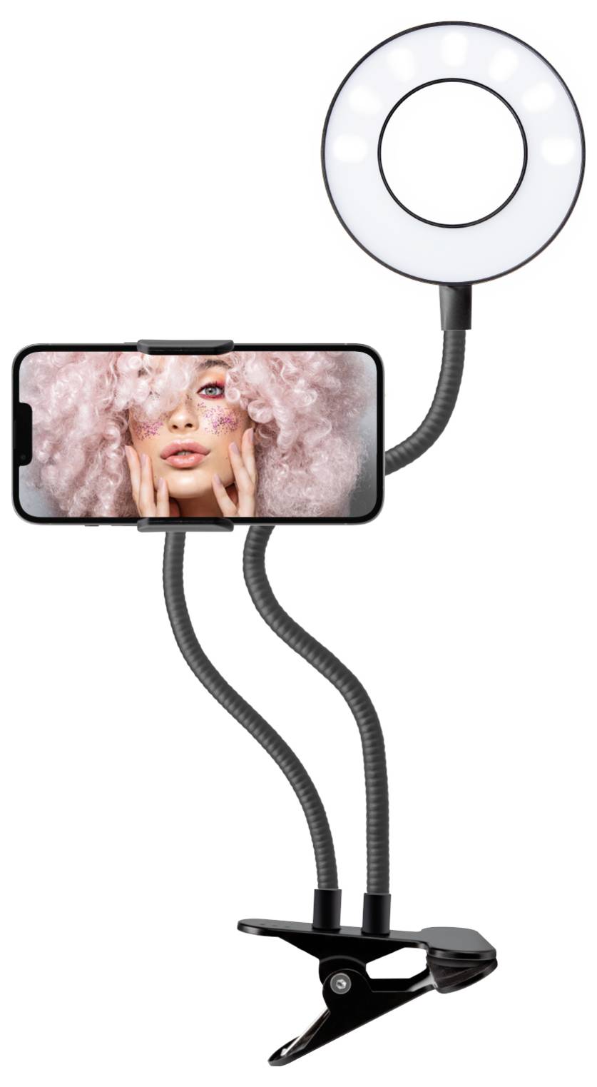 A ring light with phone holder, featuring a phone displaying a person with pink hair and artistic makeup, mounted on flexible arms with a clamp.