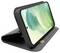 Smartphone with green abstract display in a black folding case, positioned horizontally on a stand.