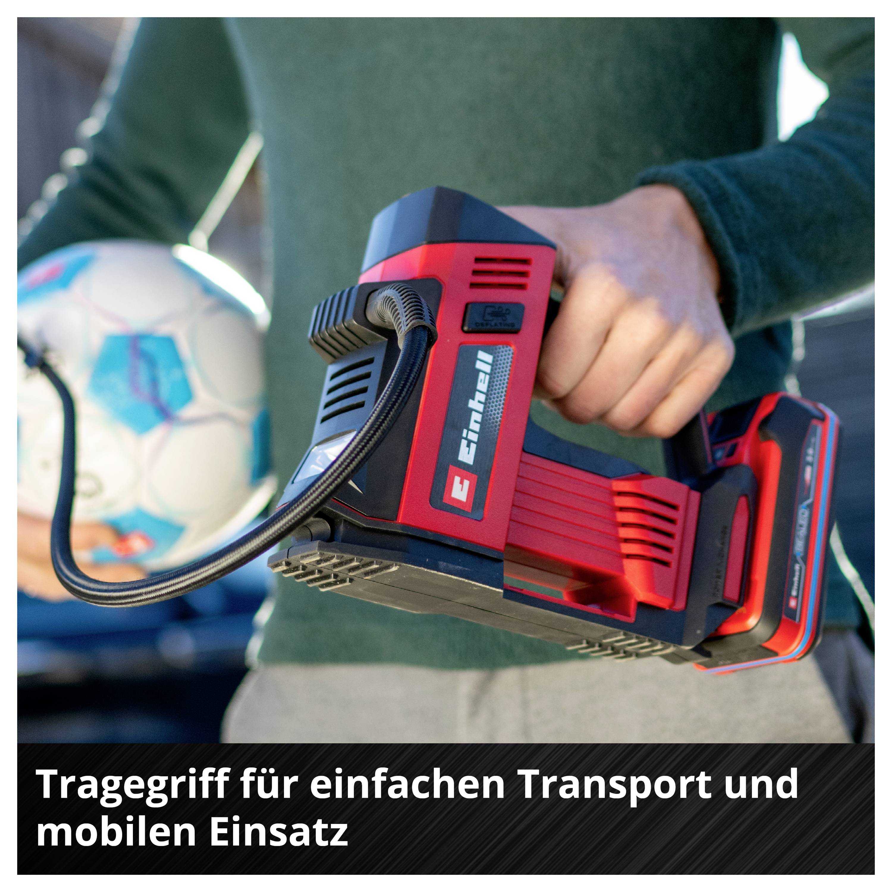 A person is holding a compressed air compressor and a football. Text: 'Carrying handle for easy transportation and mobile use'.