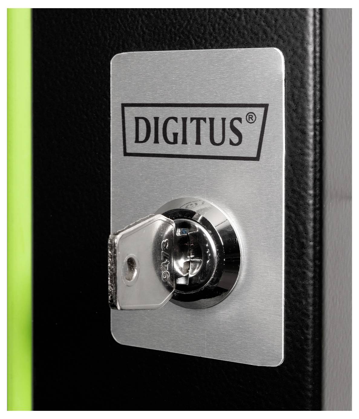 'A key inserted into a chrome lock on a metal plate labeled with the brand name Digitus, against a black and green background.'