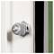 A close-up of a metal bolt secured to a white vertical surface, with a black edge on the right, showing part of a door or panel.