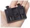 A hand holds a small black plastic component with two springs and notches, possibly part of a mechanical or electronic device.