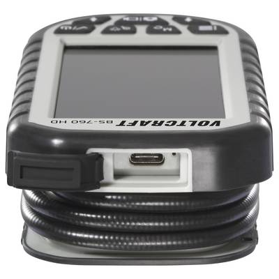 Close-up of a Voltgraft BS-760 HD handheld device with a blank screen, button controls, USB-C port, and coiled cable attached.