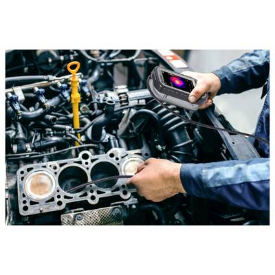 Mechanic uses a thermal camera to inspect an engine block during repair, checking for heat issues or leaks.<br>