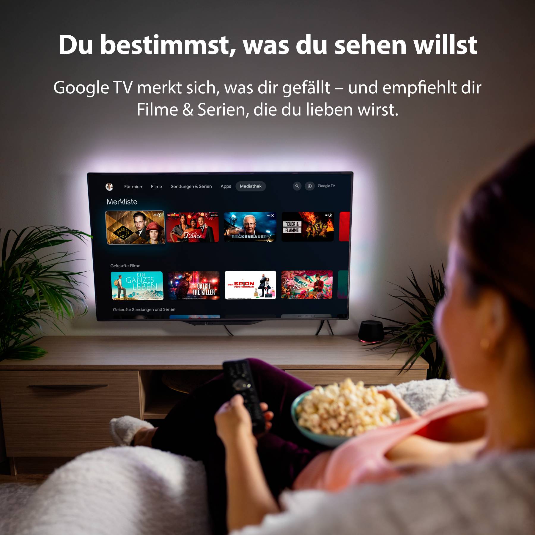 A television displays streaming services. A person sits holding a remote control, with a bowl of popcorn beside them. Text at the top reads: 'You choose what you want to watch'.