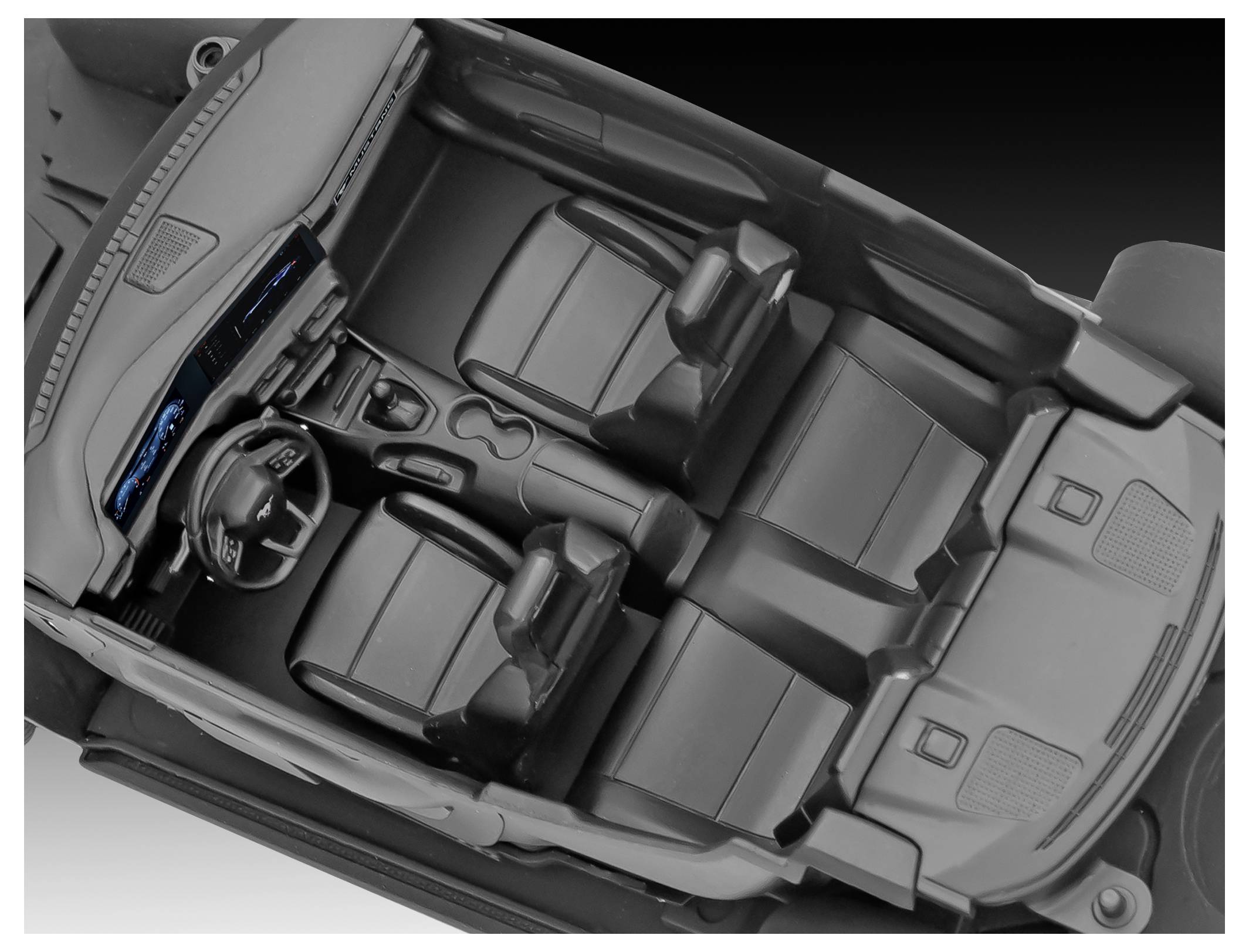 View of a car's interior from above, showing the dashboard, steering wheel, two front seats, and two back seats with a console.