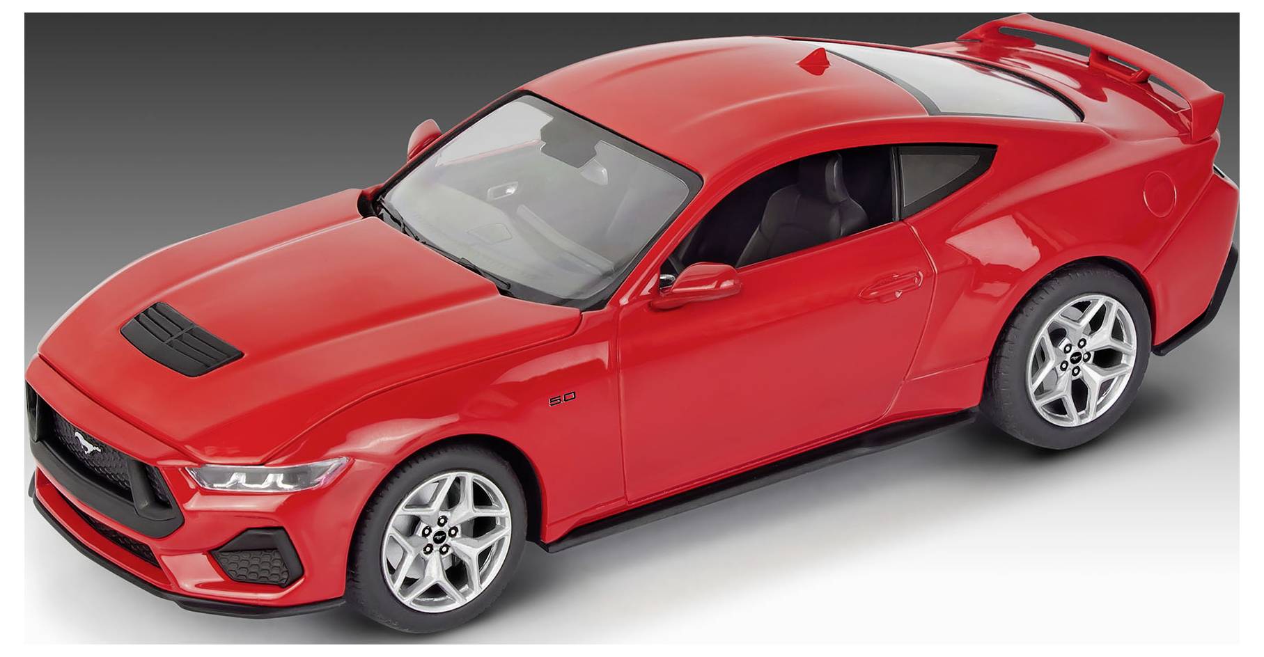 A red sports car model with black accents viewed from an elevated angle, showcasing sleek design and aerodynamic features.