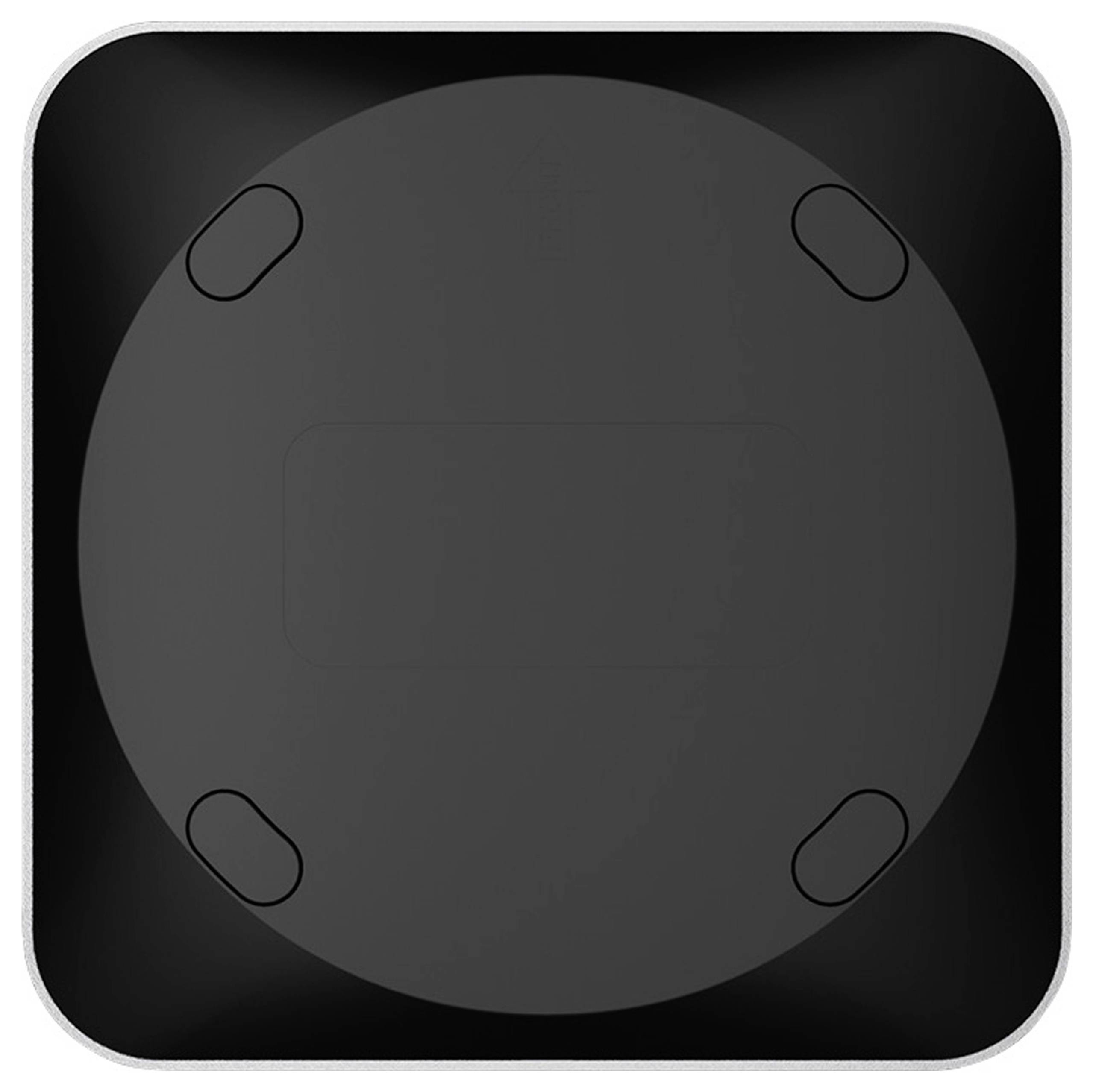 A black circular object with rounded edges, viewed from the top, featuring four small oval shapes evenly spaced around the perimeter.