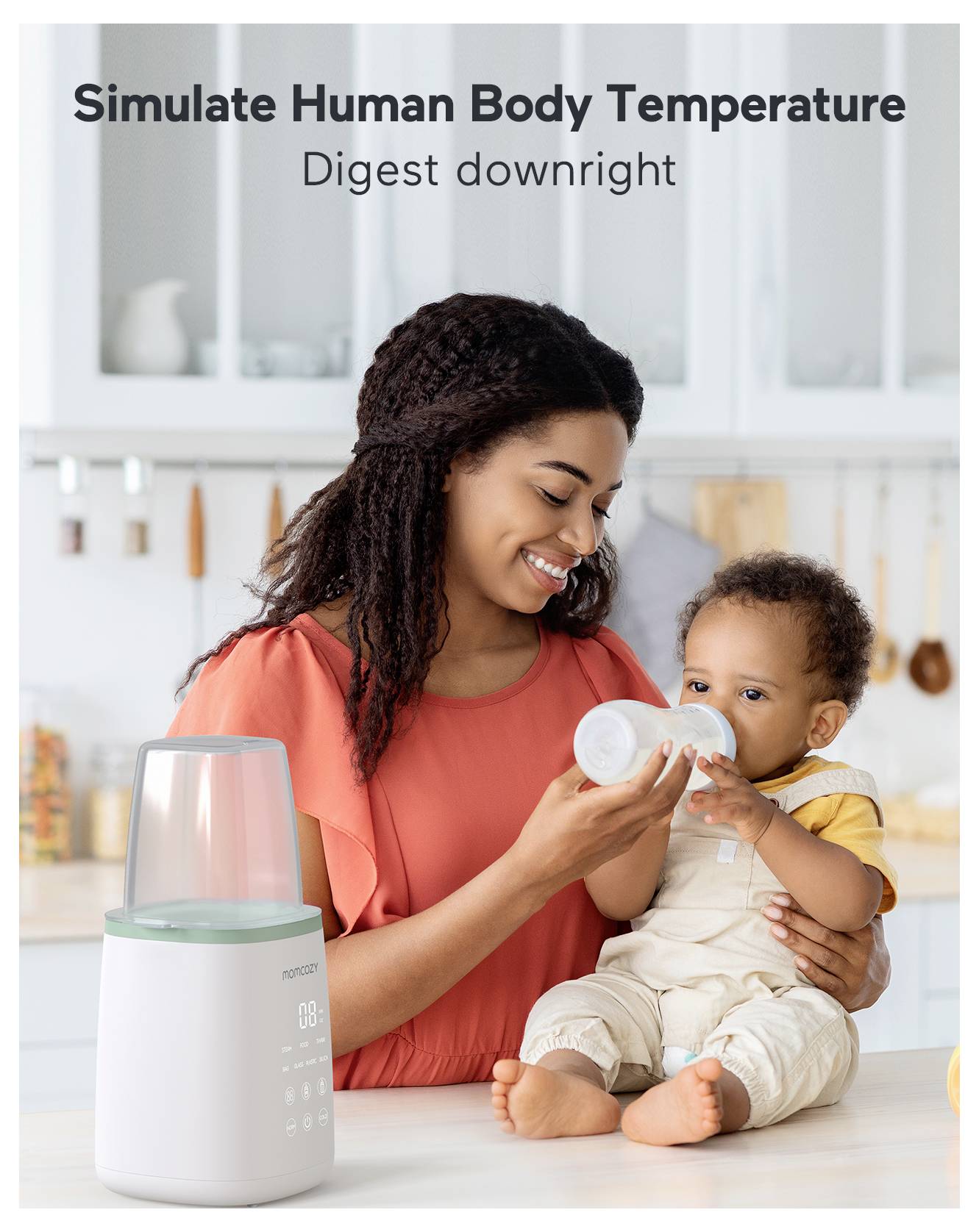 A woman feeds a baby with a bottle in a kitchen. Text above reads 'Simulate Human Body Temperature. Digest downright.'