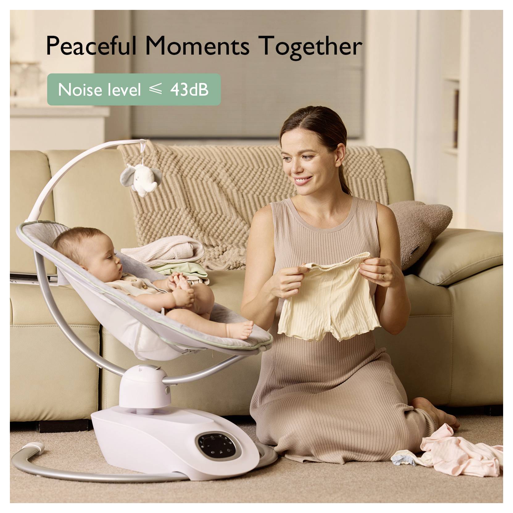 A woman sits on a sofa smiling at a baby in a baby swing. Text reads 'Peaceful Moments Together'. Noise level shown as ≤ 43dB.