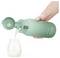 A hand pouring milk from a green thermos into a baby bottle. The thermos displays '98°F' indicating the temperature.