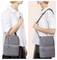 'A person demonstrates two ways to carry a gray insulated lunch bag by hand and over the shoulder, highlighting its versatility.'