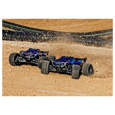 Two remote-controlled cars race on a dirt track, kicking up dust as they navigate a curve, showcasing speed and maneuverability.