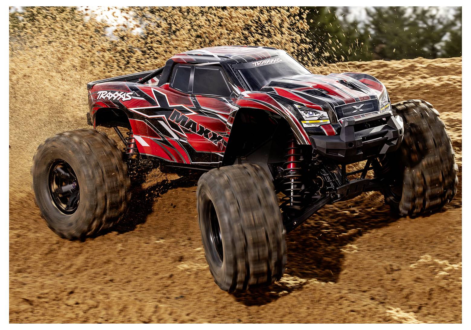 A red and black remote-controlled monster truck with large tires drives through dirt, creating a dust trail behind it.