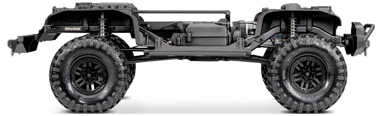 A chassis of a rugged off-road vehicle, showing large tires, suspension details, and a central frame without a body.