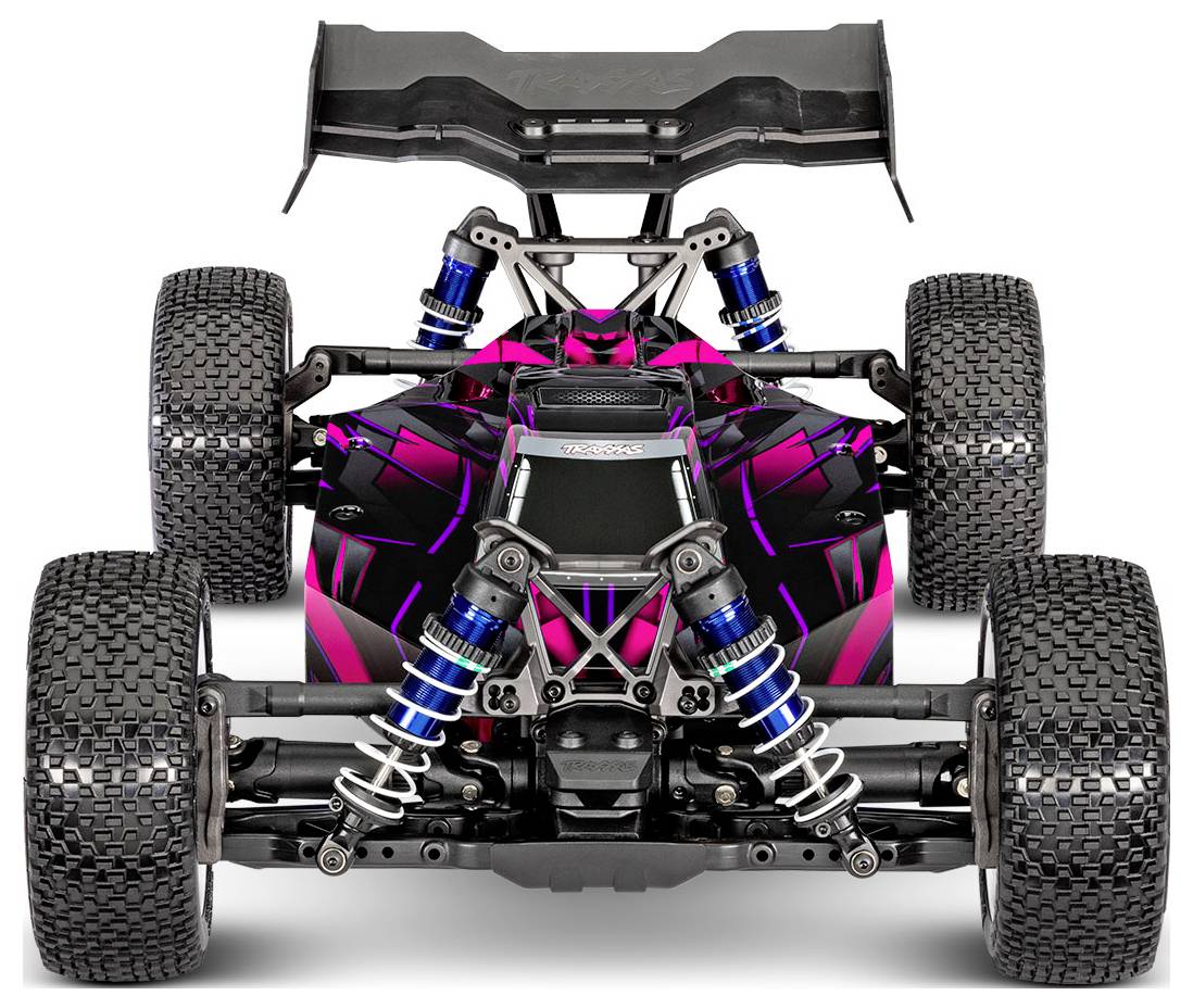 A pink and black remote-controlled car with visible suspension springs and large, textured tires, shown from the front.