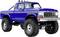 A blue, vintage Ford truck with large off-road tires and a roll bar is shown at an angle, showcasing its rugged design.