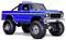 A blue toy truck modeled after a classic Ford off-road vehicle with large tires, chrome details, and roof lights.