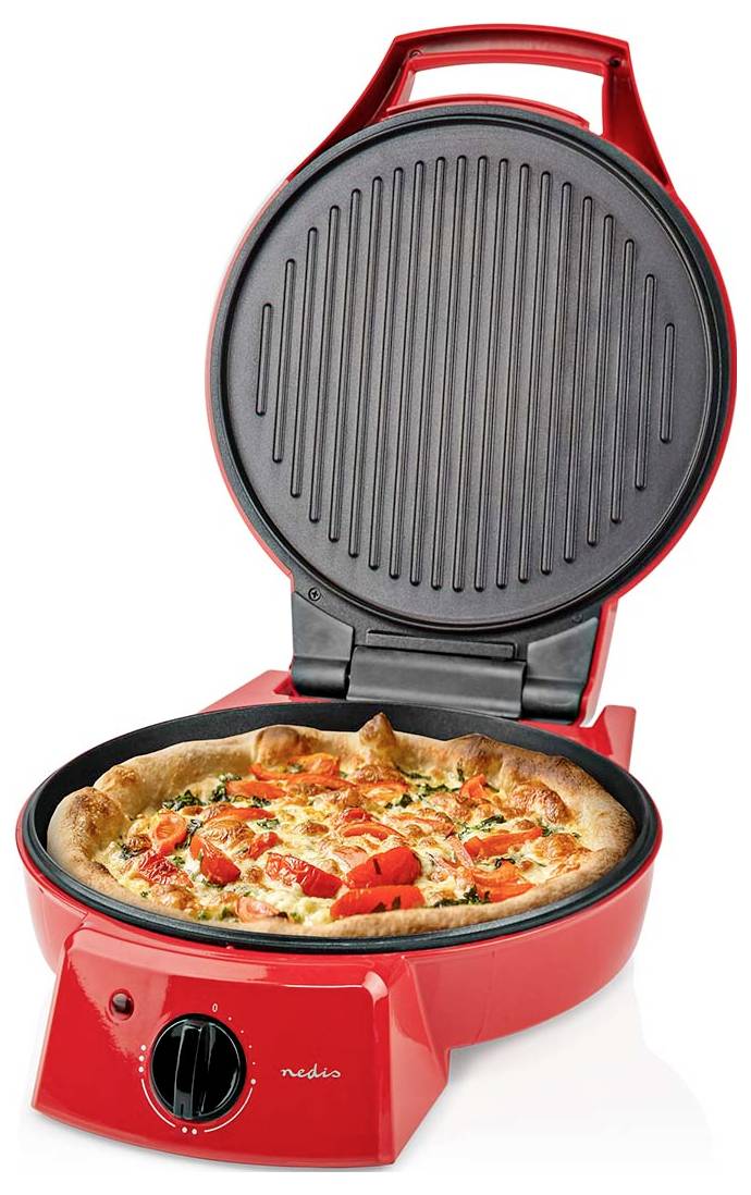 A red pizza maker with an open lid displaying a cooked pizza topped with cheese, tomatoes, and herbs inside.